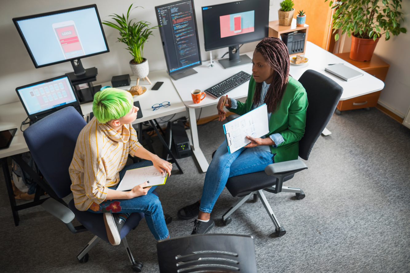 Blue-haired app developer working.
